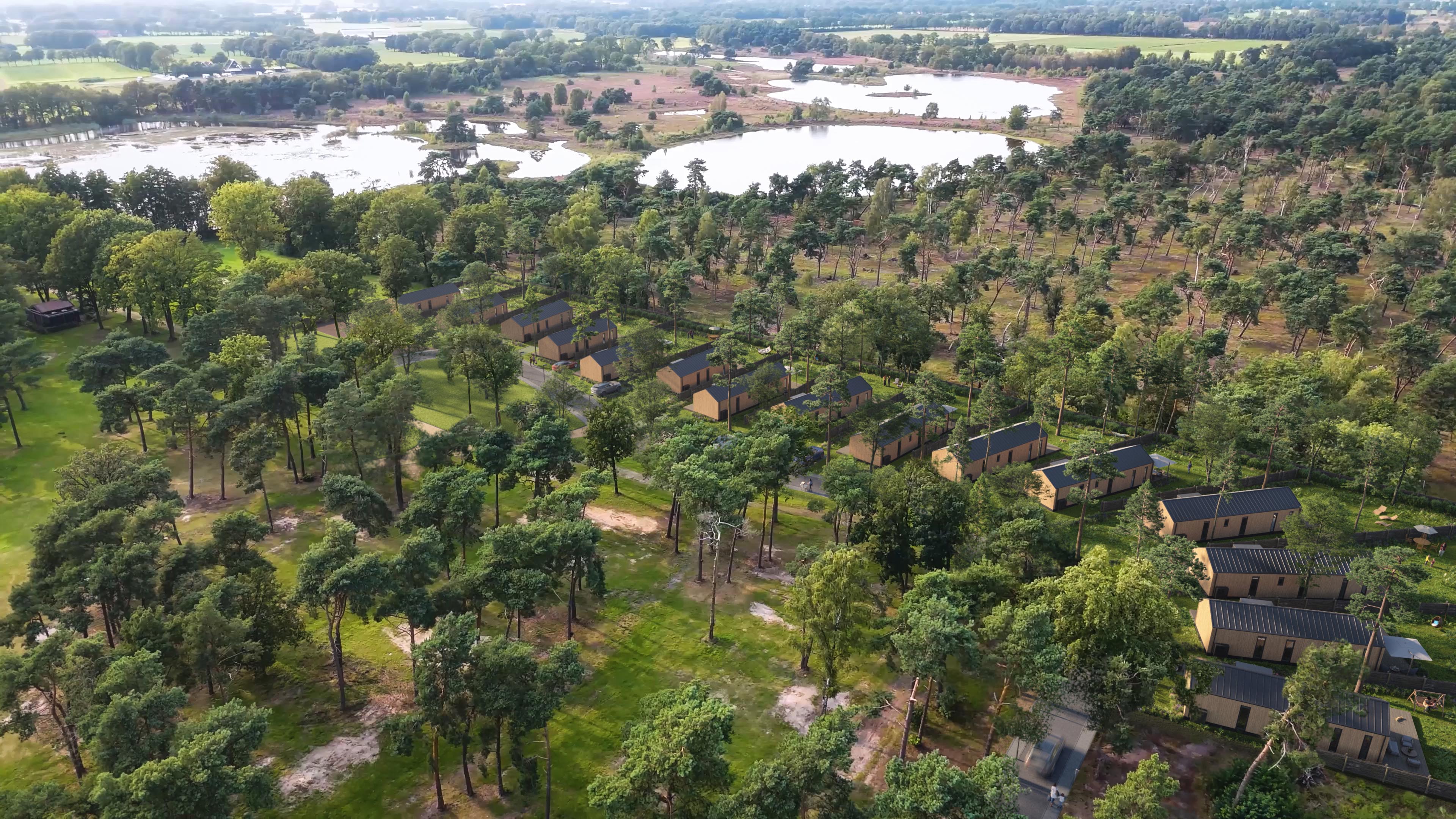 Aerial view of Bergvennen timber-clad lodges among trees near lakes in Lattrop-Breklenkamp, Netherlands