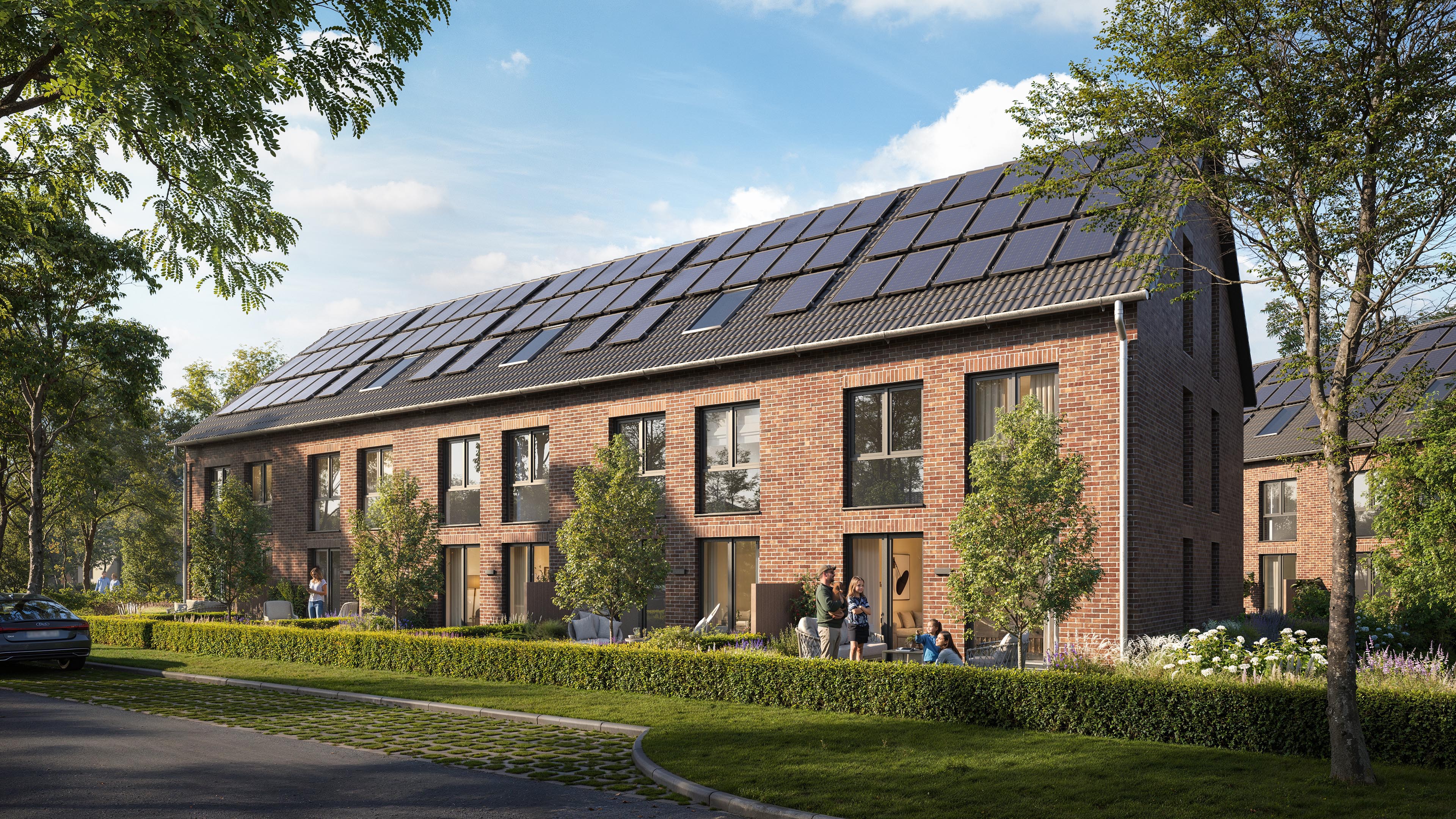Guldener Hofe brick homes in Reppenstedt with rooftop solar panels and hedge-lined garden terraces