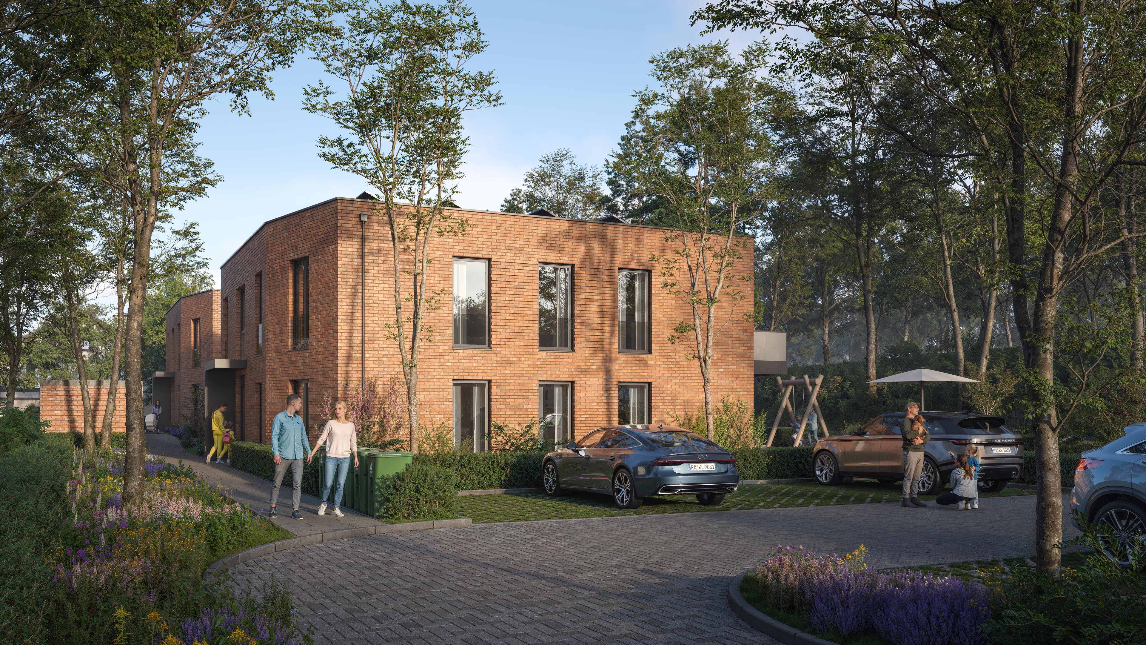 Wohnen am Petersberg brick apartments with landscaped entrance paths and grass-paved parking spaces